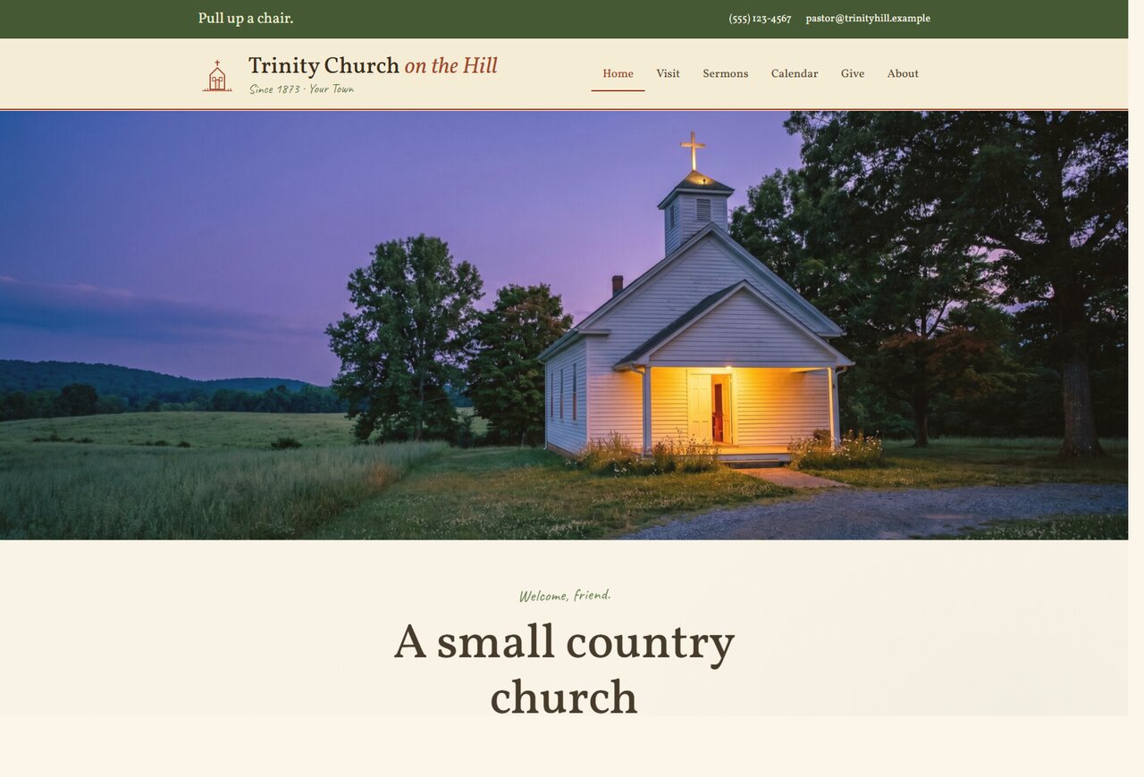A small white country church glowing at dusk